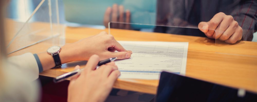 Cliente firmando el recibo de un envío en el mostrador de una tienda