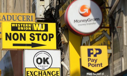 Several Western Union, MoneyGram and Pay Point commercials are seen on a street in downtown.